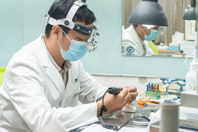 dental laboratory technician work on prosthesis